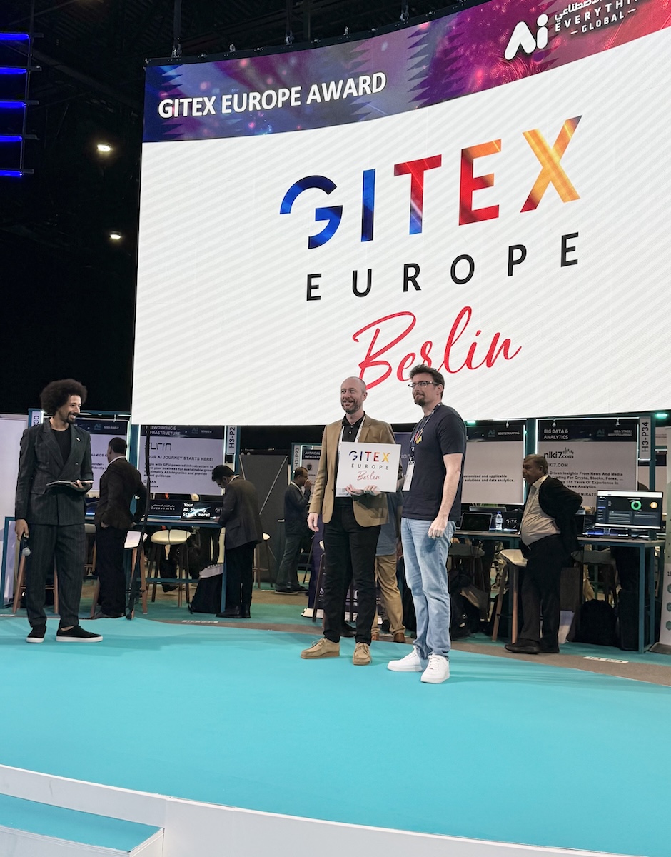 Professional.me team members receiving the GITEX Europe Berlin prize on stage.